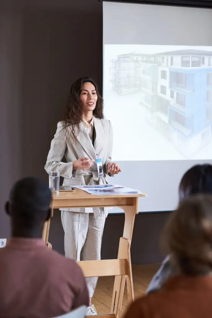 Businesswoman performing at seminar for people